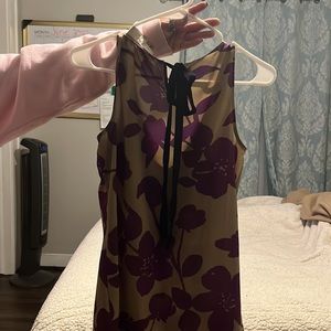 Purple and khaki shirt with a black bow tie in the back